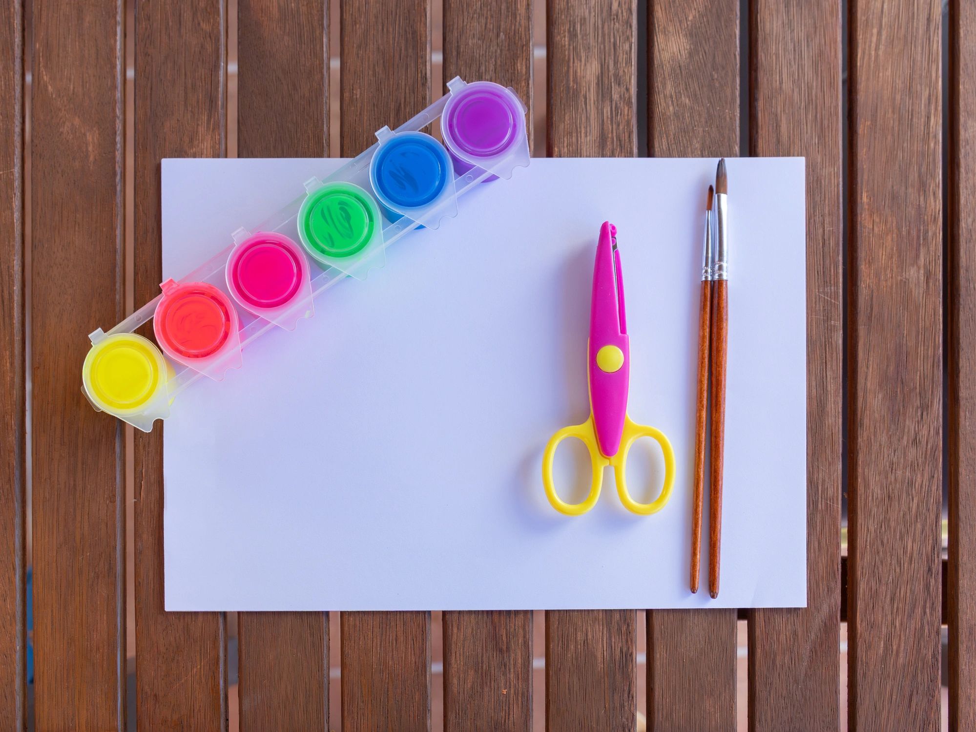 Colorful paint supplies and tools arranged for a creative project