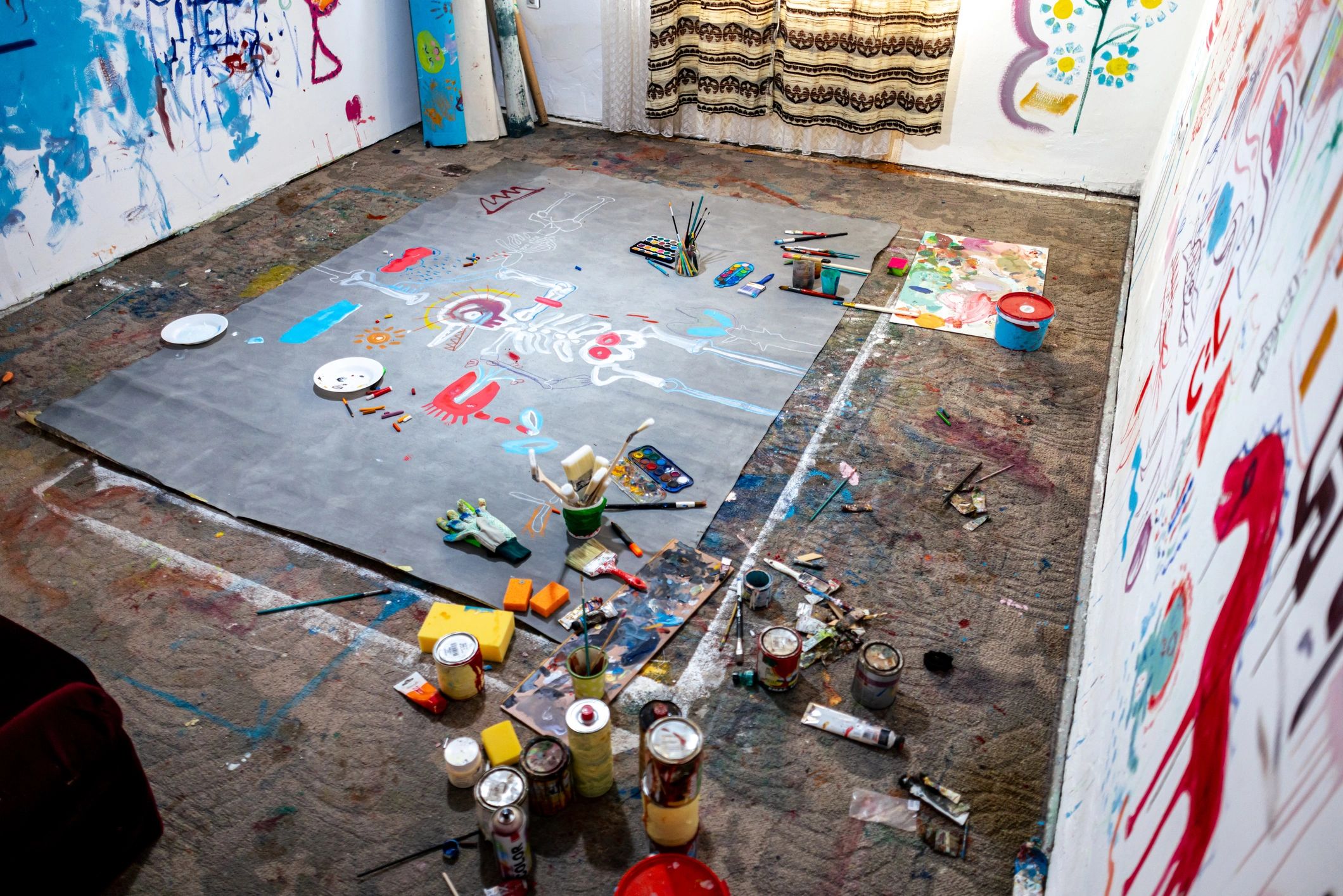 Large scale abstract painting in a colorful creative workspace